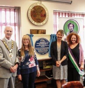A group of people around a blue plaque for Baroness Alice Bacon
