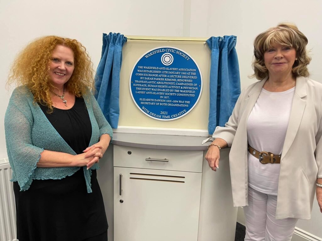 Project leader Sarah Cobham stands by a newly unveiled blue plaque to Elizabeth Dawson and Sarah Parker Remond.