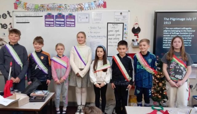 children wearing suffragist sashes during a history talk by the forgotten women of wakefield group