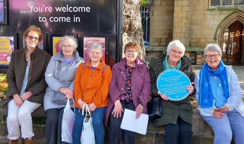 A group of Mothers' Union members with Mabel Norton's blue plaque outside Wakefield Cathedral