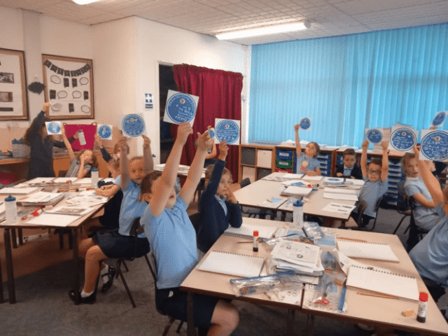 School children talking part in activities during a history talk