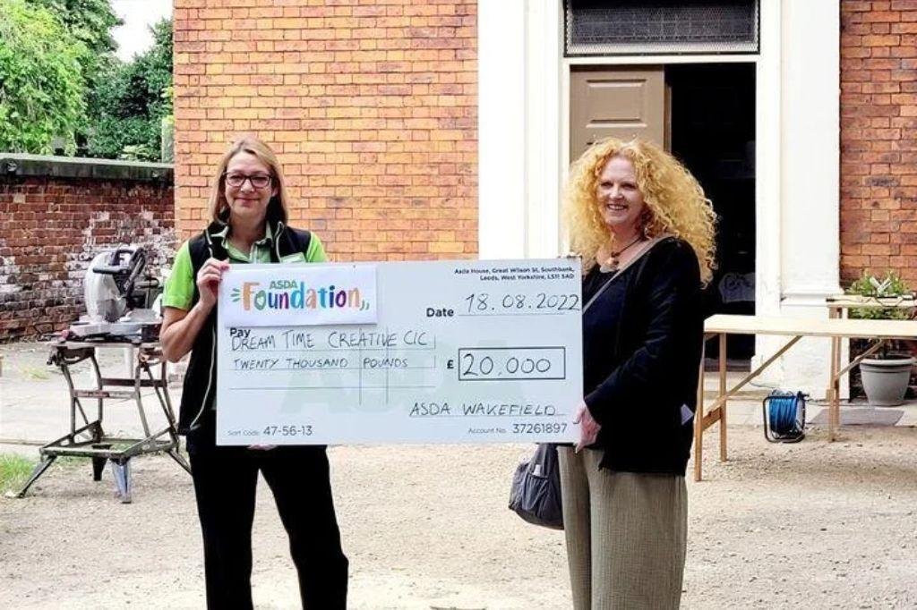 Sarah Cobham receiving the cheque from the Asda Foundation